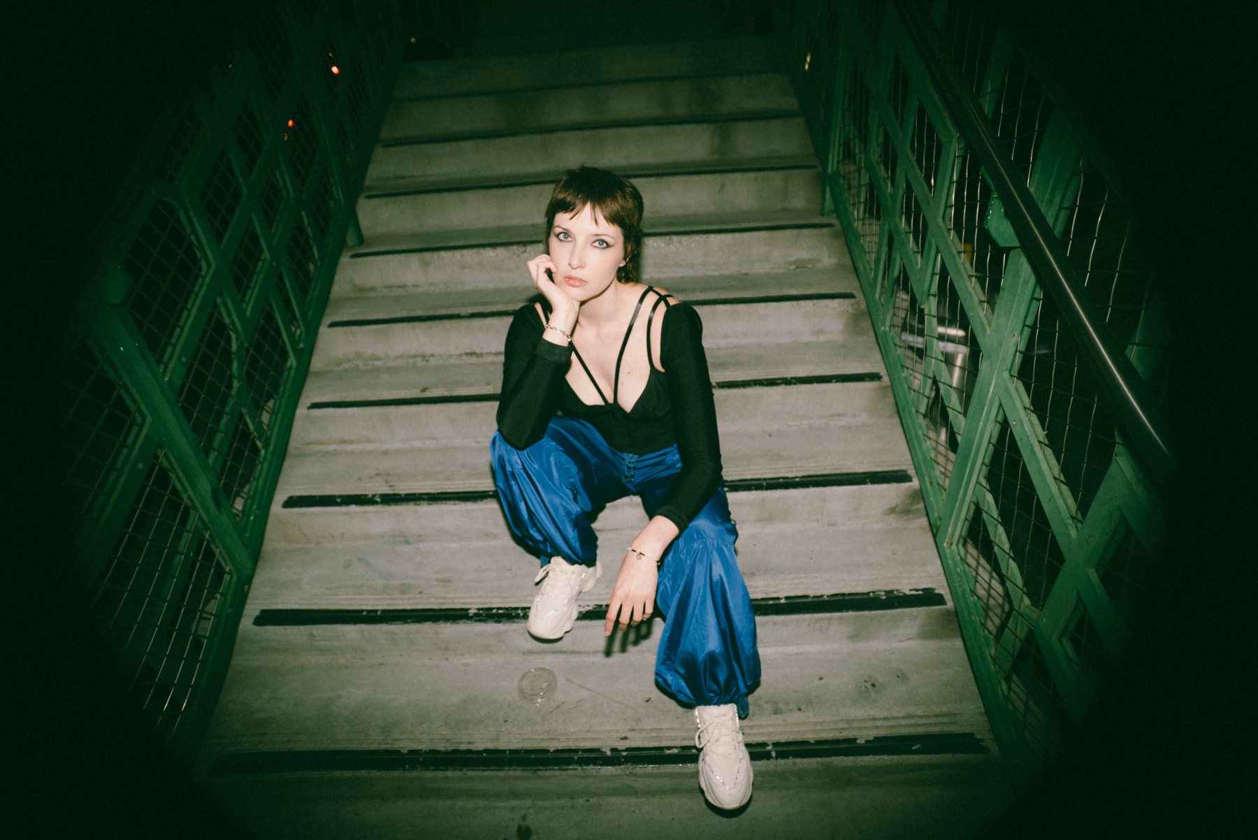 Sulene seated on a stairwell